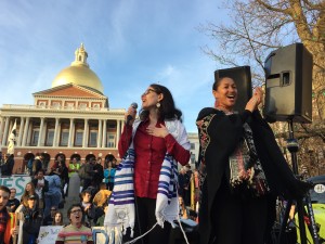 Rabbi Shoshana Meira Friedman leads singing with rally MC, Mariama White Hammond