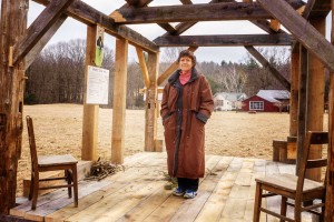 Margaret stands in the 10 x 15 foot cabin in Ashfield modeled by Will Elwell after Thoreau’s cabin at Walden Pond, photo by Robert A. Jonas