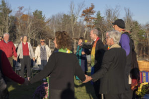 Holding hands and singing, with Rev. Andrea Ayvazian and Rev. Dr. Jim Antal in foreground. Photo credit: Robert A. Jonas